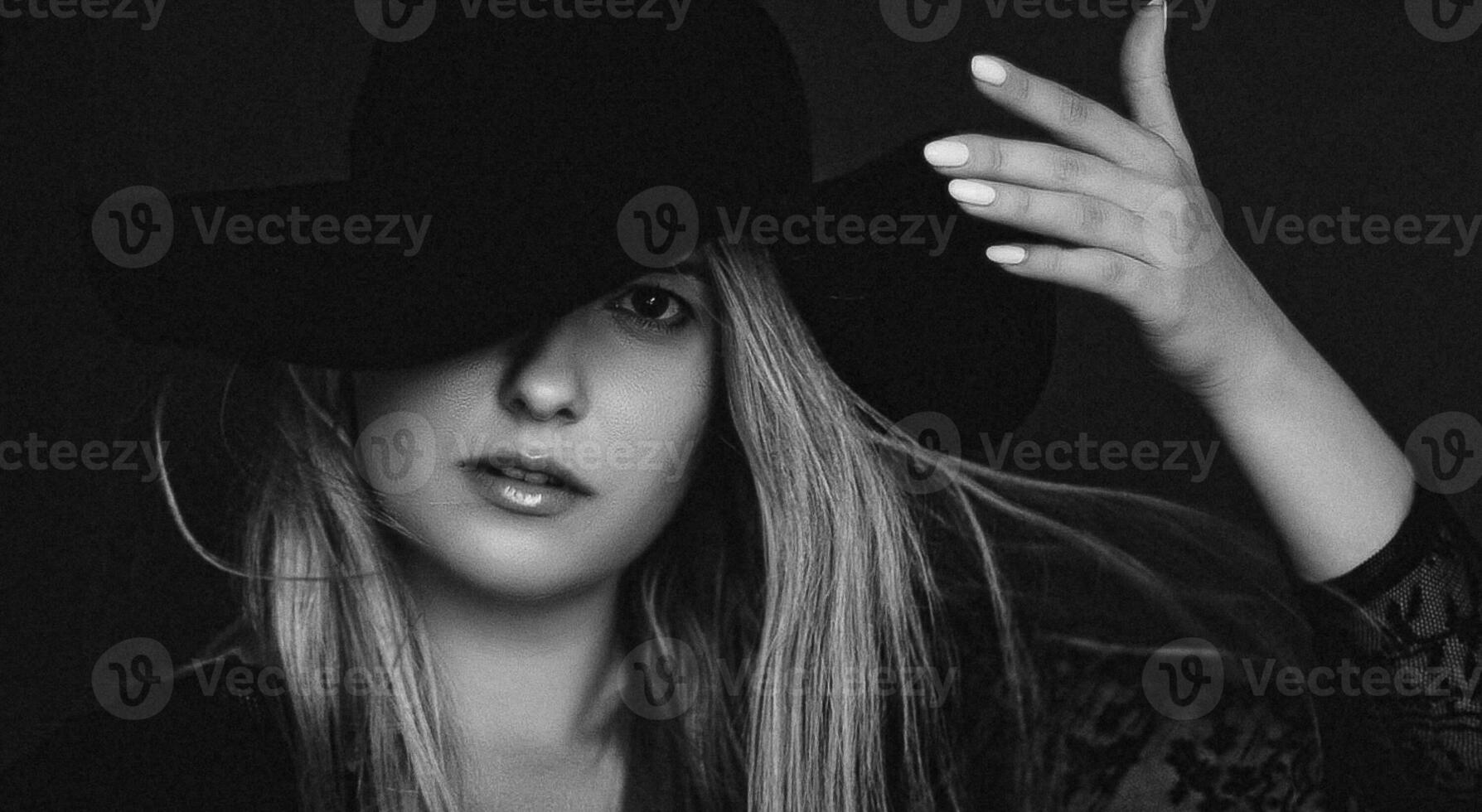 Beautiful blonde woman wearing a hat, artistic film portrait in black and white for fashion campaign and beauty brand photo