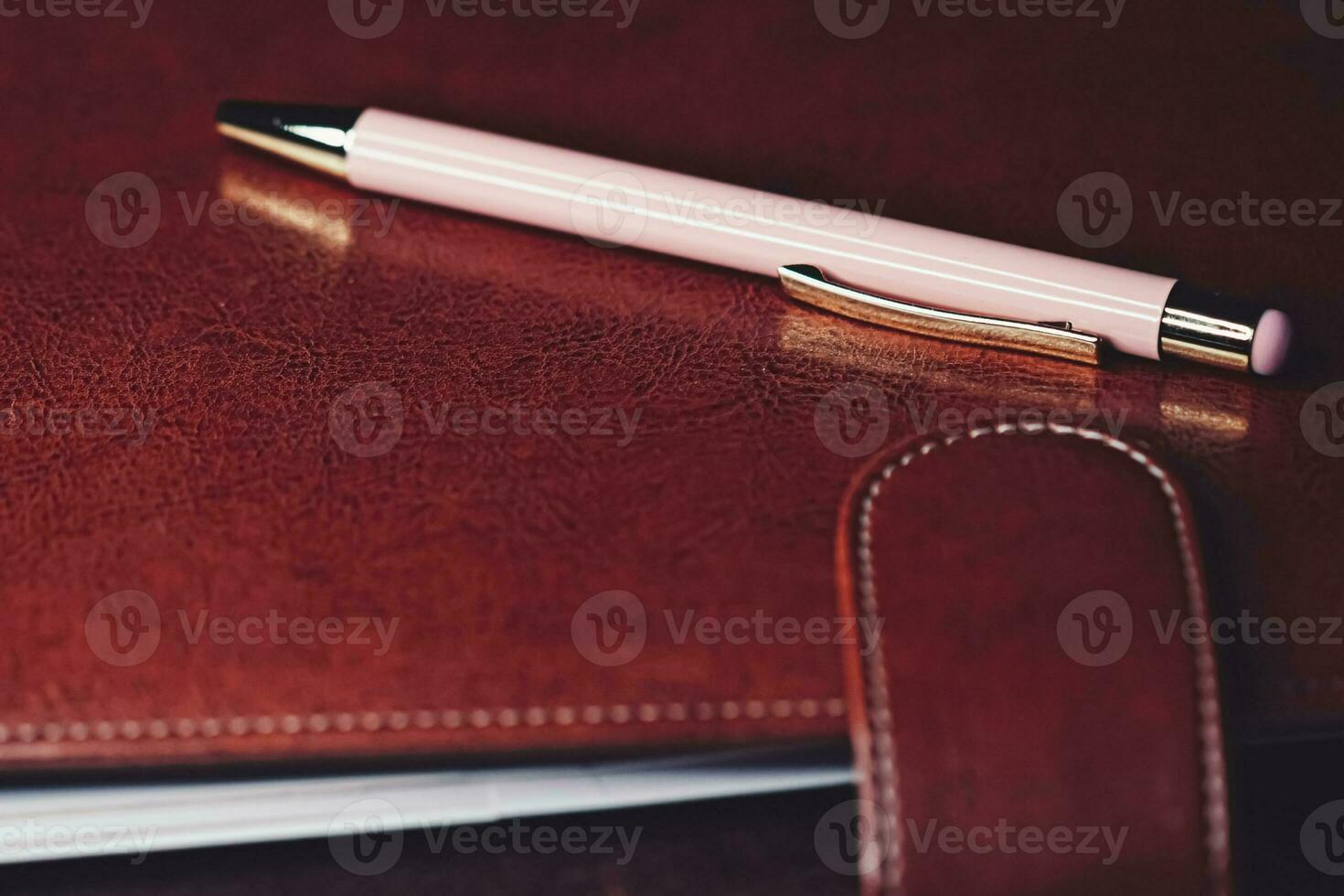 Pen and leather briefcase in office photo