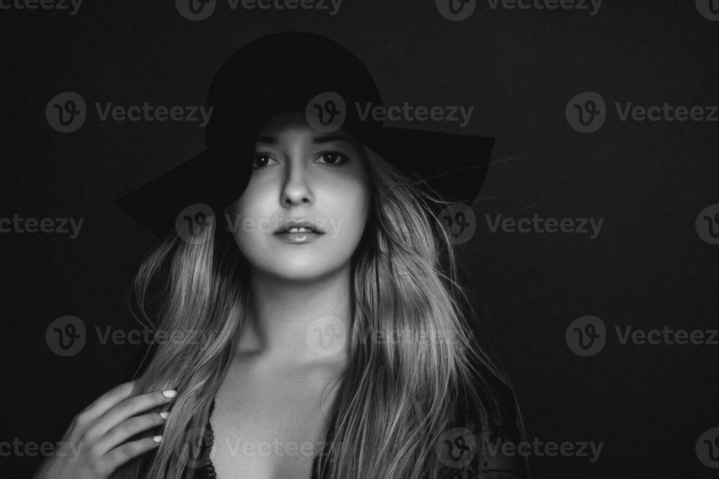 Beautiful blonde woman wearing a hat, artistic film portrait in black and white for fashion campaign and beauty brand photo