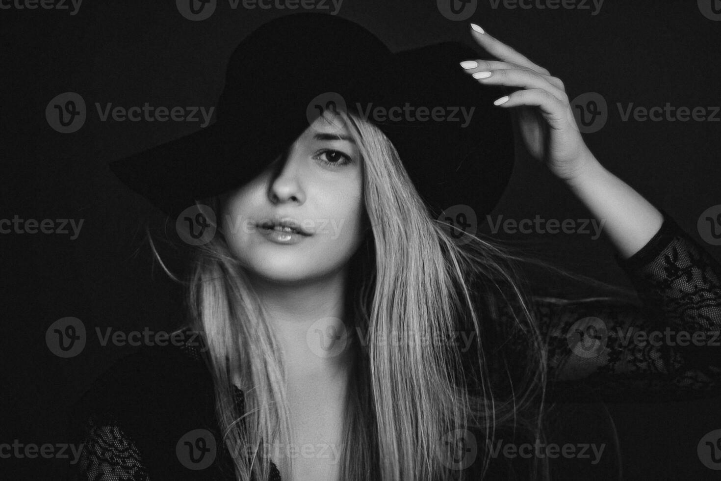 Beautiful blonde woman wearing a hat, artistic film portrait in black and white for fashion campaign and beauty brand photo