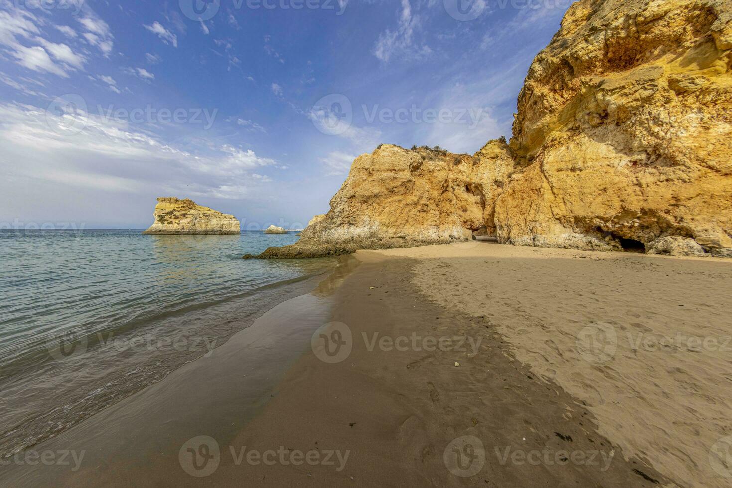 Panoramic picture between the cliffs at Praia do Prainha on the Portuguese Algarve coast during the day photo