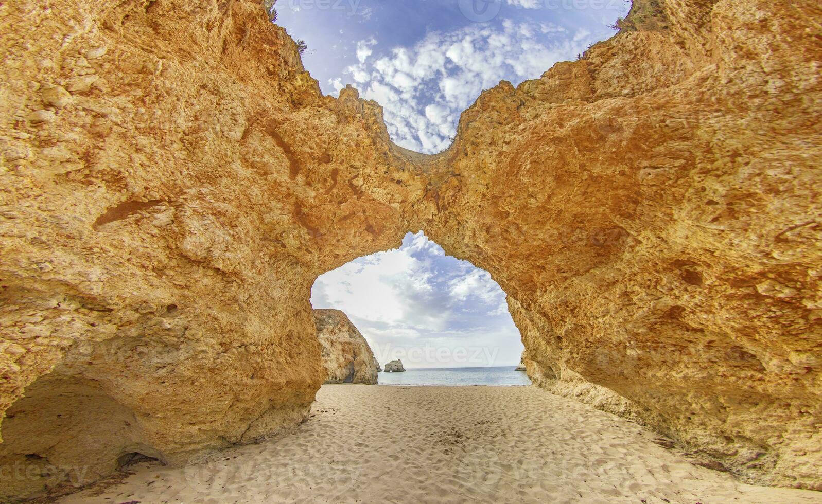 Panoramic picture between the cliffs at Praia do Prainha on the Portuguese Algarve coast during the day photo