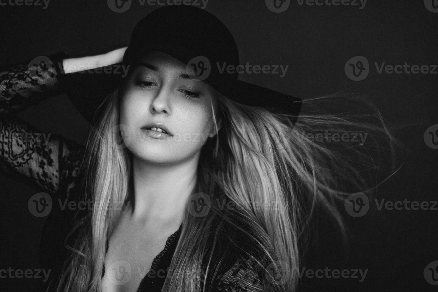 Beautiful blonde woman wearing a hat, artistic film portrait in black and white for fashion campaign and beauty brand photo