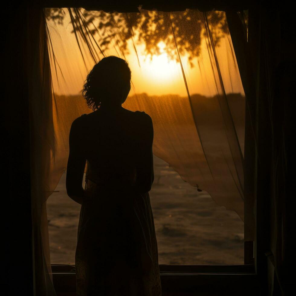 Woman silhouette through dusty window photo