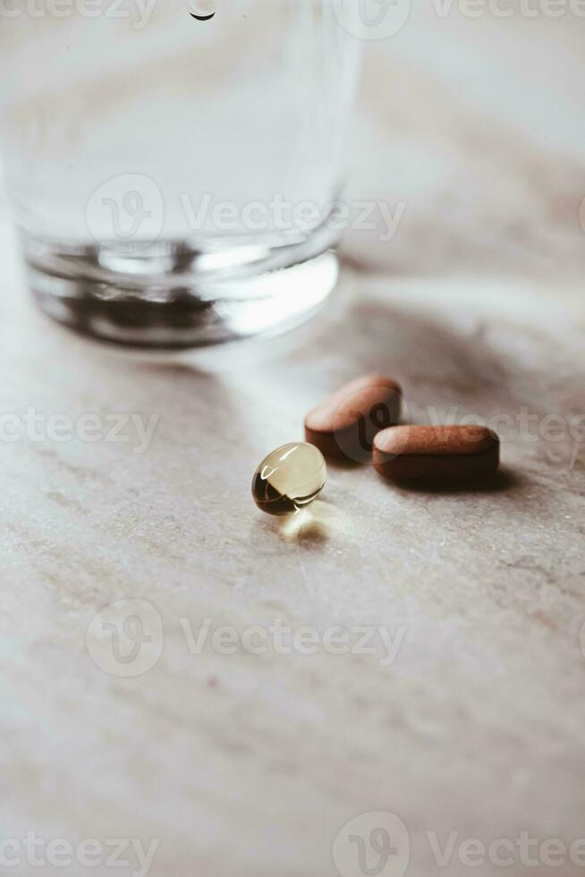 Medical pills and glass of water, health and wellness photo