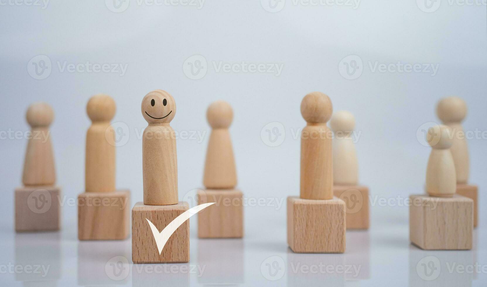 Concept Business and HR for leadership and team leader, one wooden dolls different and stand out from the group. photo