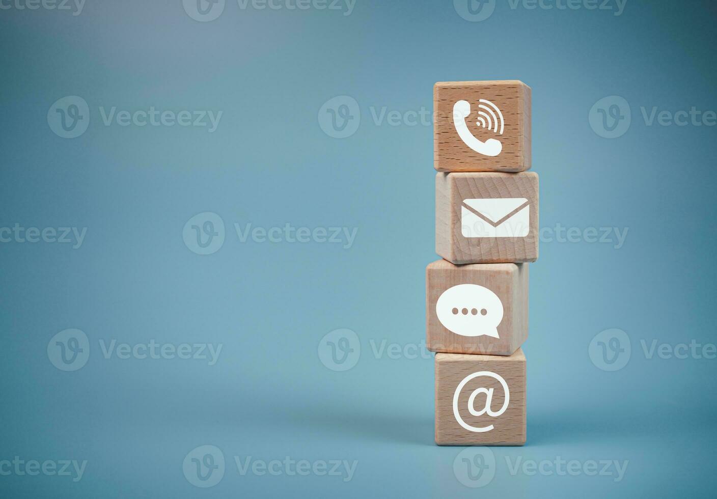 Stacked wooden blocks and communication icons. Website page, contact us or email marketing concept, customer support hotline, contact us, email, phone, address, chat message icon. photo
