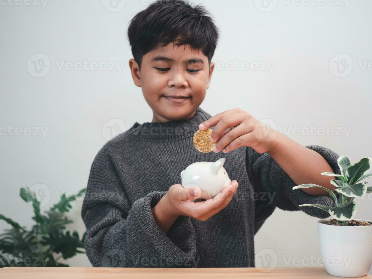 A boy putting coins into piggy bank. Learning financial responsibility and projecting savings. savings concept. investment concept. photo