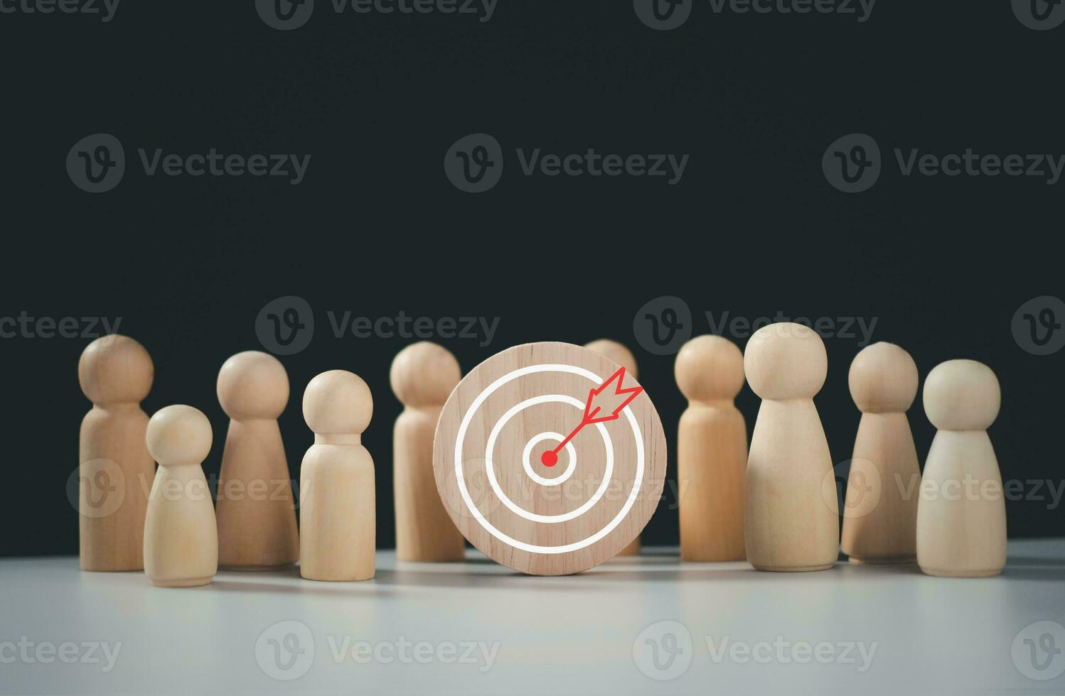 Target concept of business and personnel in a company. wooden dolls standing around Dart board and arrows for creating and targeting business objectives. Marketing solutions photo