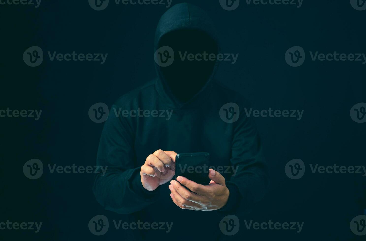 Hackers work on phone in the dark. The concept of information security in the Internet network and information espionage. Virus attack. Hacker attack. photo