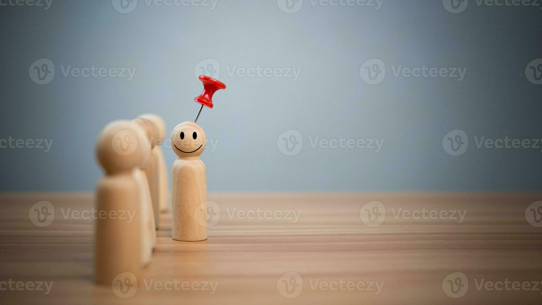 Business and human resources concept for leadership and team leader. A red pin pinned on one wooden doll stands apart and stands out from the crowd. photo
