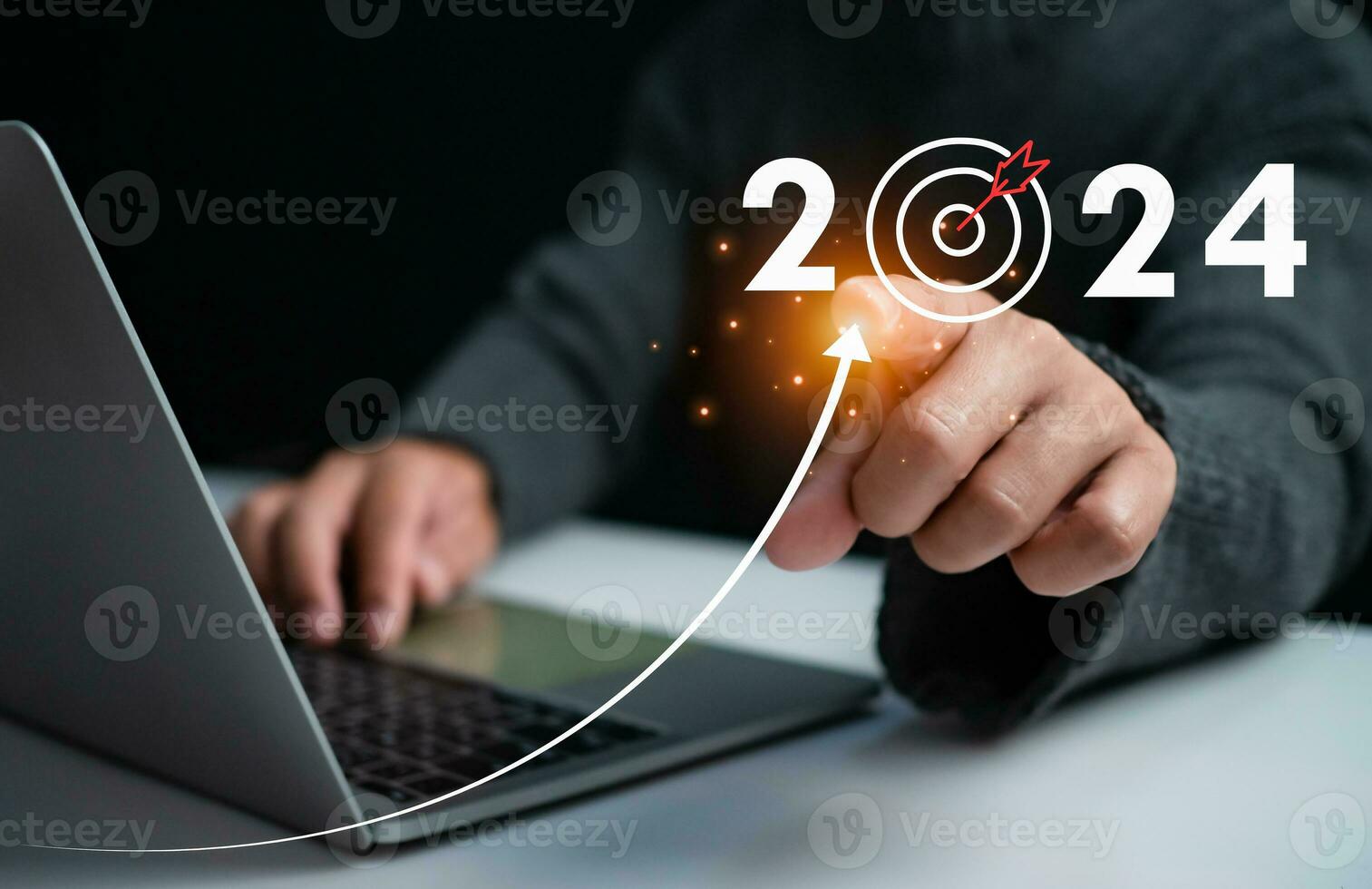 Businessman pointing at dart board icon Represents the goal setting for 2024, concept of startup, financial planning, development strategy, business goal setting. photo