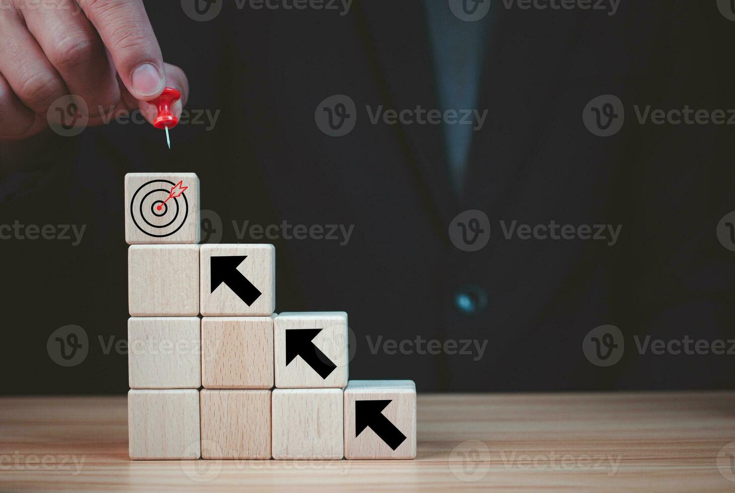 Businessman pin in the selection of target on wooden block which prints a target icon. Business goals and objectives concept. business competition. business strategy photo