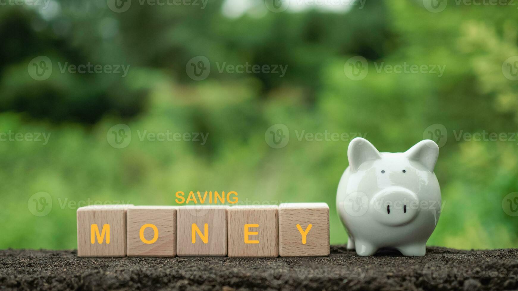White piggy bank on nature background. Concept of savings and investment. photo