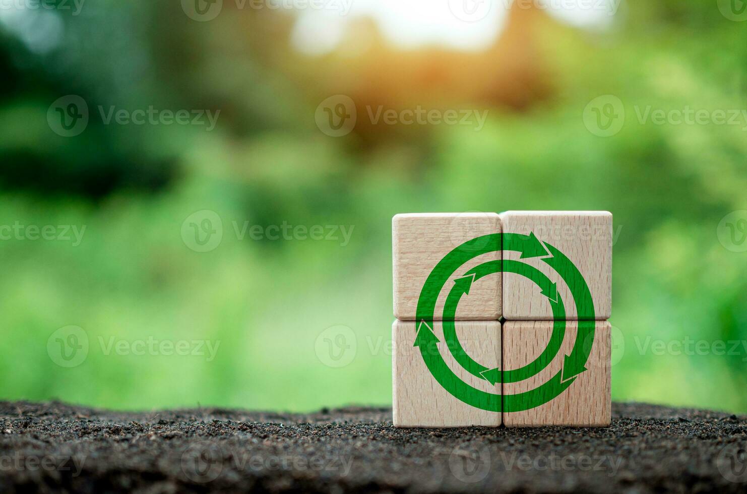 Concepts of waste reduction, pollution, reuse, efficient use of resources. Environmental protection sign by recycling on circular wooden blocks on nature background. photo