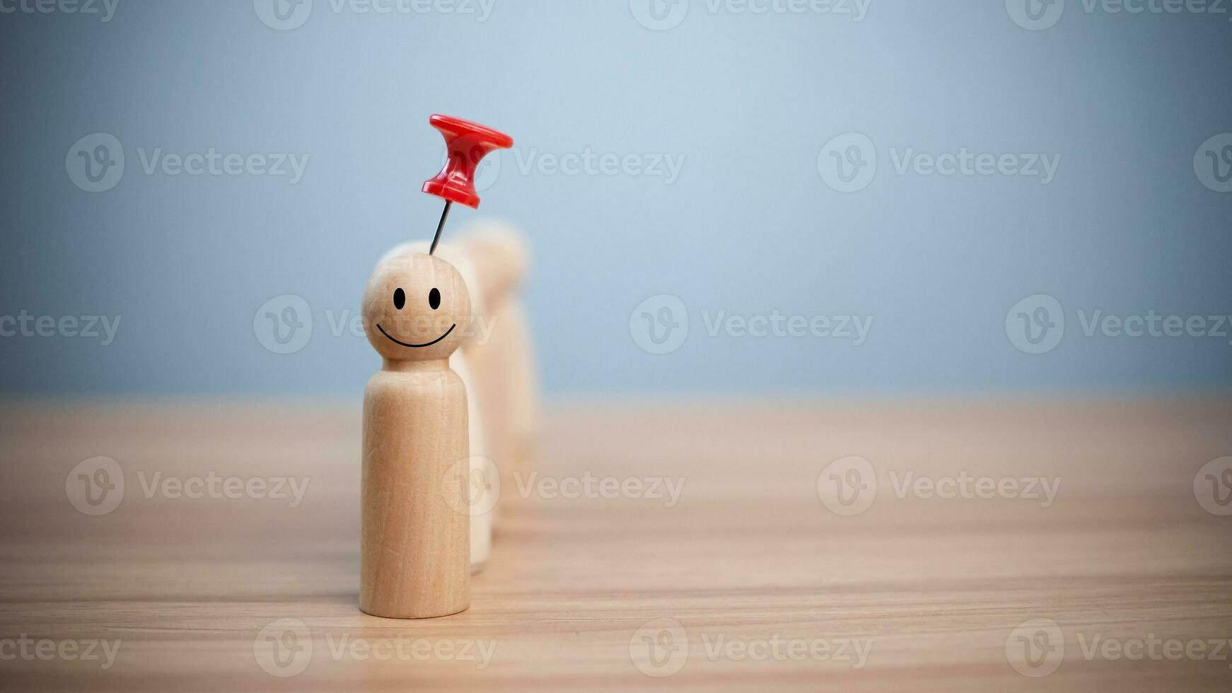 Business and human resources concept for leadership and team leader. A red pin pinned on one wooden doll stands apart and stands out from the crowd. photo