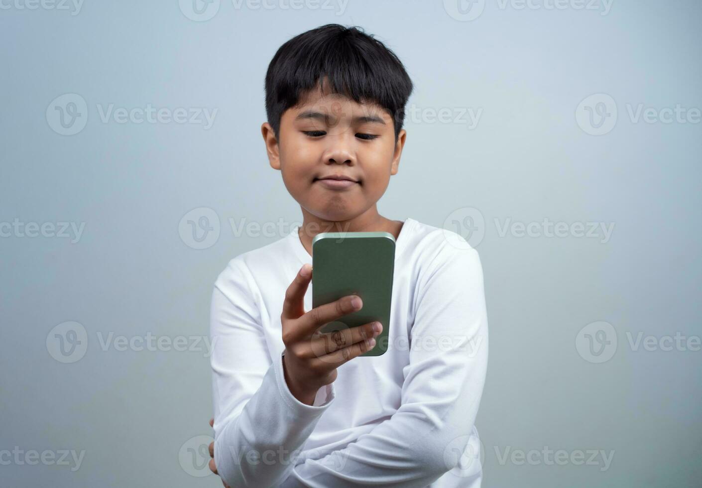 Social media and technology concepts. Boy's hands holding a smartphone and stylus pencil to use multimedia and social media to communicate. photo