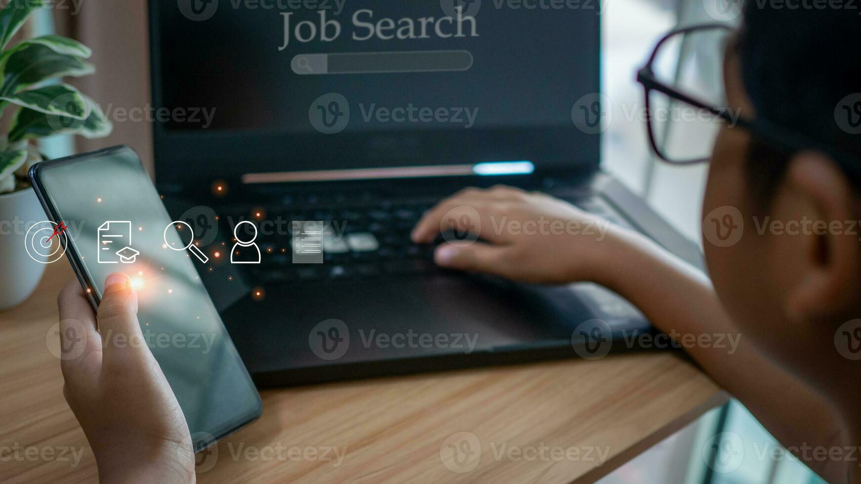 Human holding  smart phone and using computer laptop to job search on online internet. applying for a job concept. photo