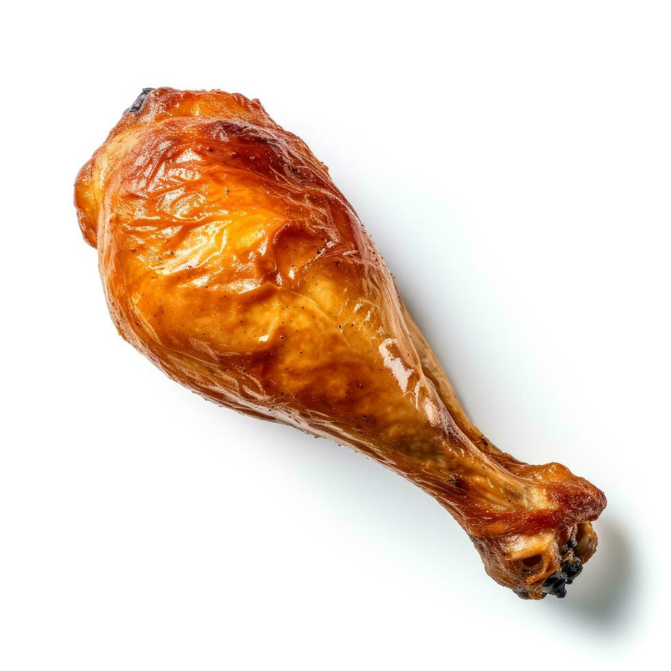 Crisp golden roasted chicken drumstick starkly isolated on a white background photo