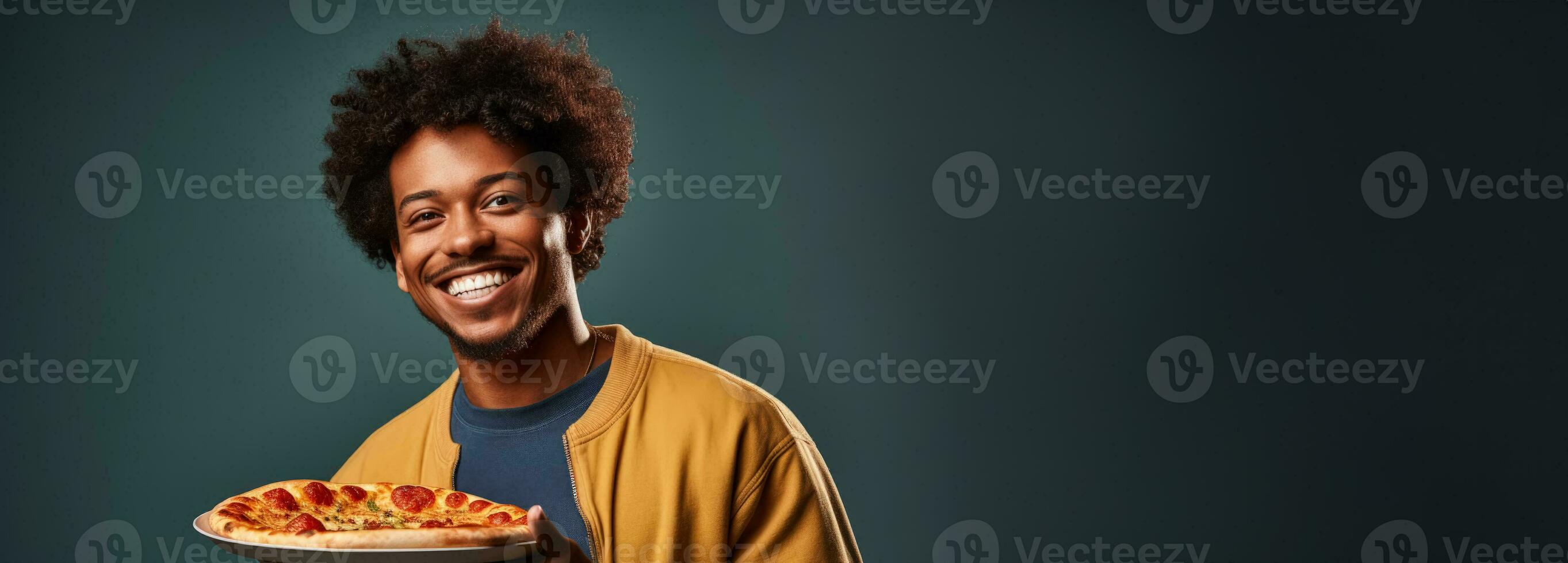 College student enjoying pizza during study break isolated on a cafeteria gradient background photo