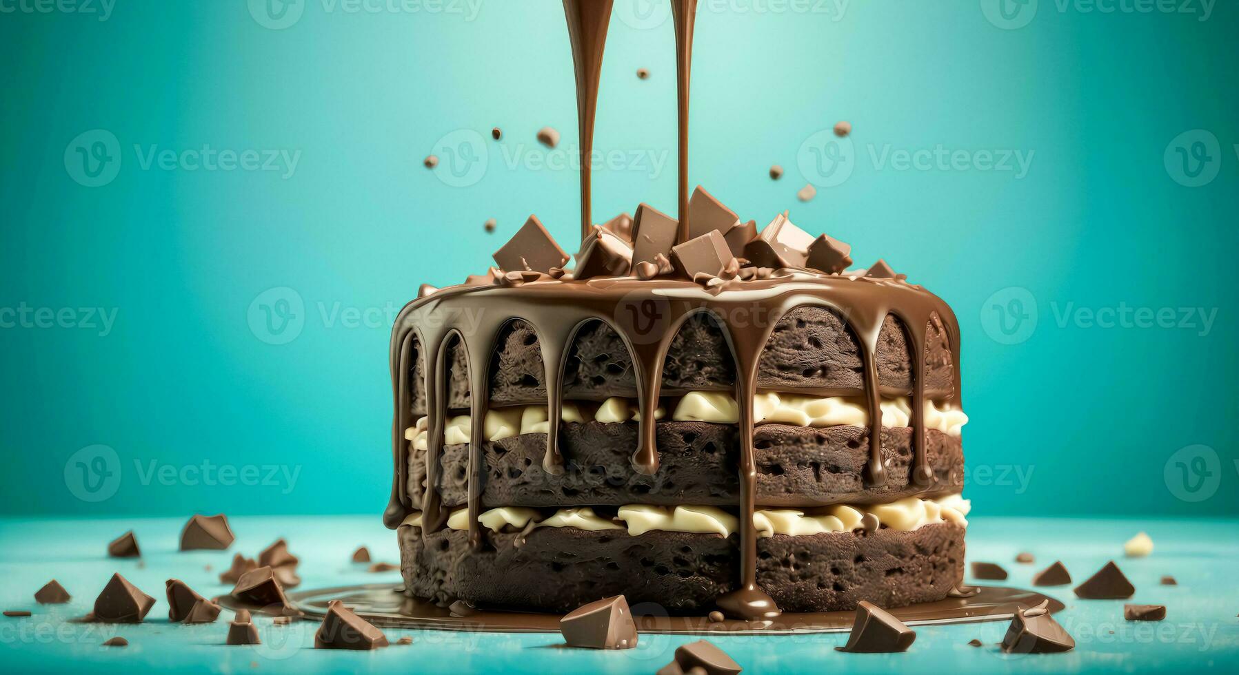 Tasty Cake On Teal Background With Chocolate Chips And Flowing Streams Of Cream photo