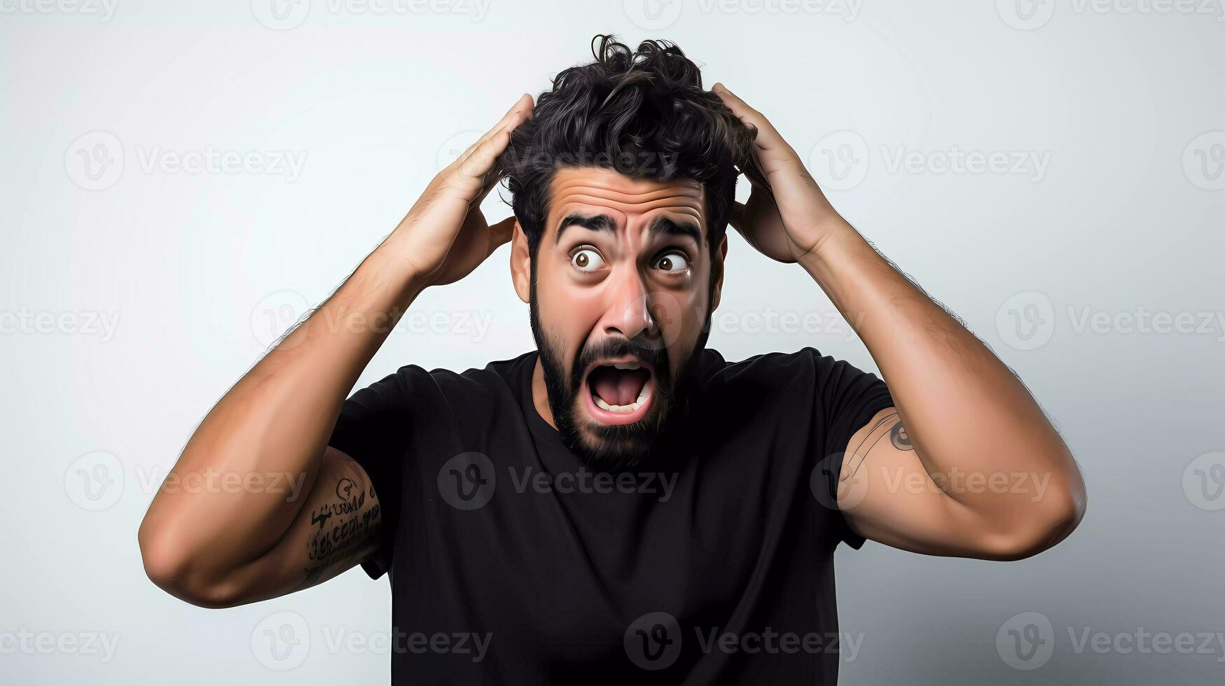 Portrait of man with beard wearing T-shirt standing with mouth open in surprise, has shocked expression photo