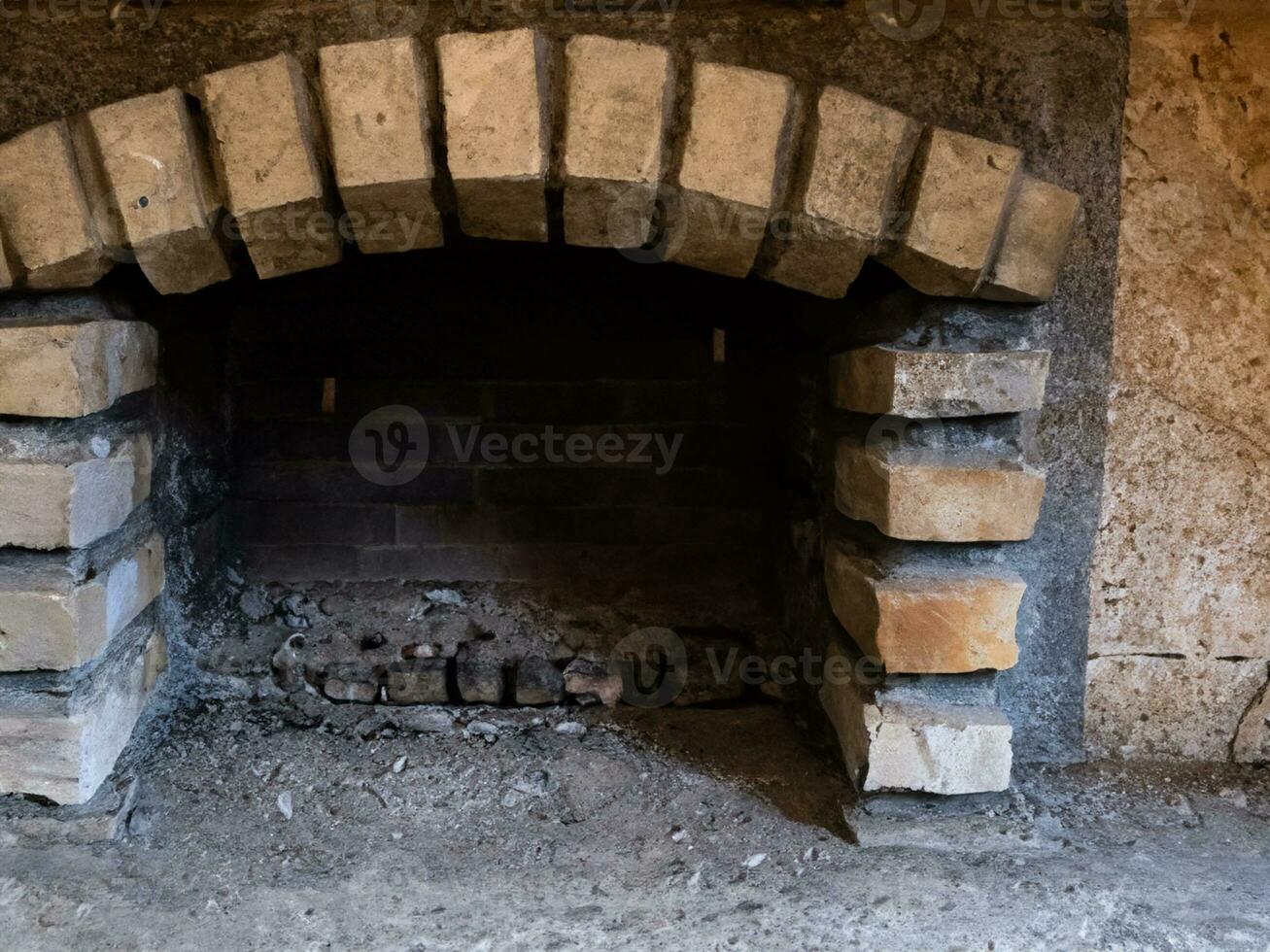 old stone stove with a large fire in the village photo