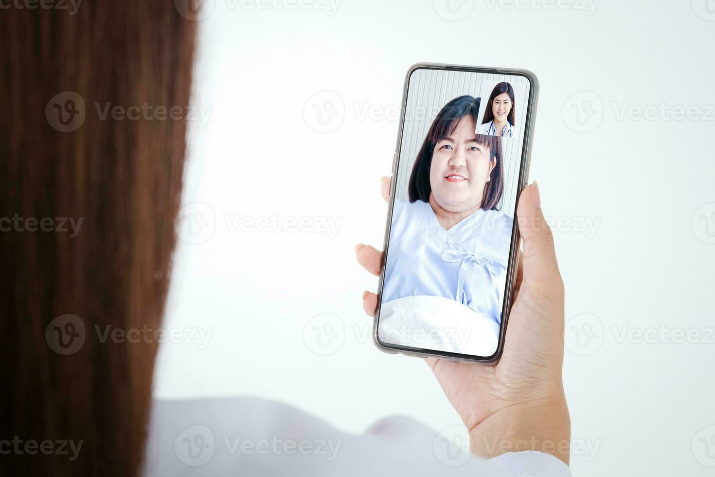 Online doctor concept Monitor patient health through a black smartphone connected to communication via online technology. The doctor can examine the patient via video call. White background photo