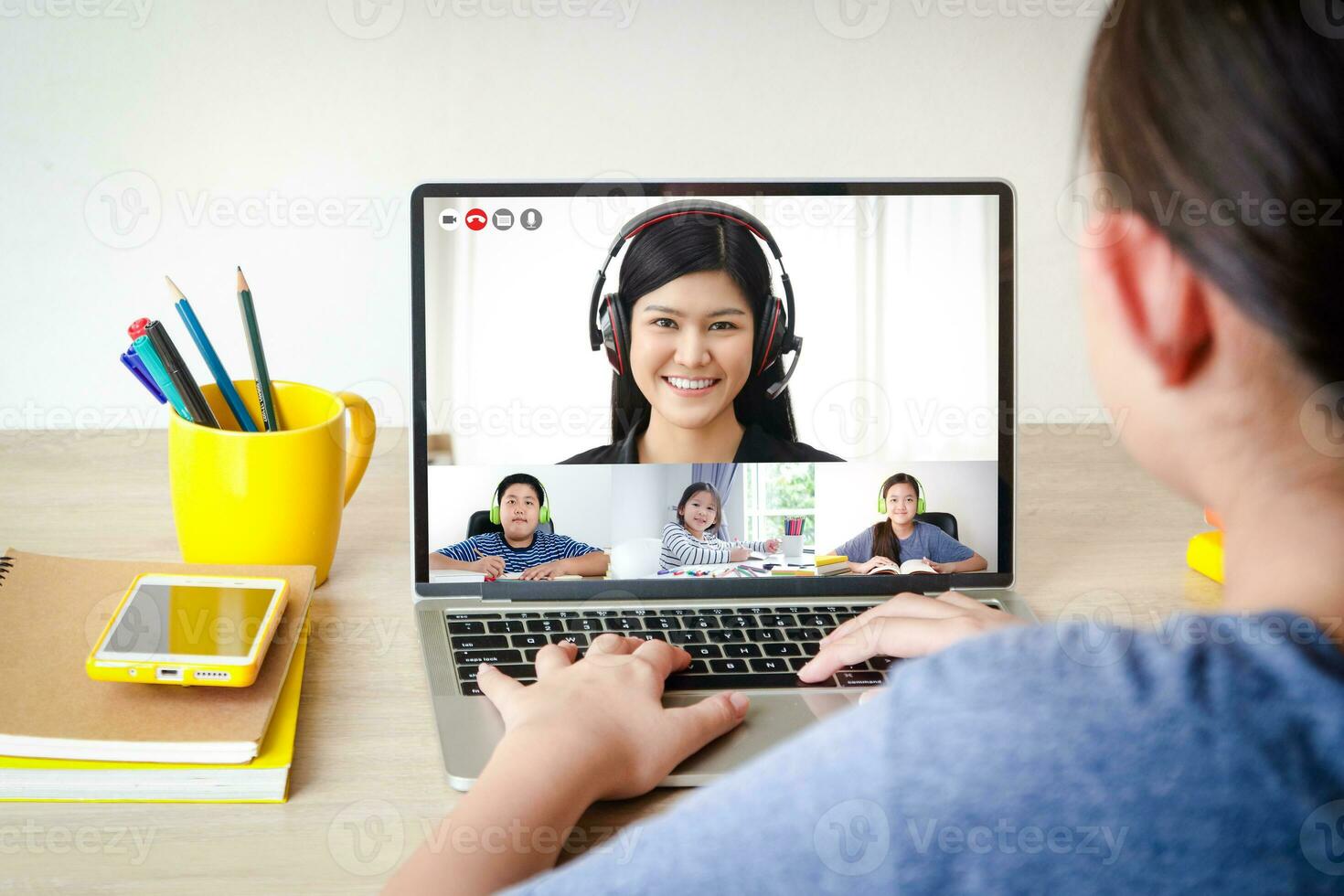 Asian schoolgirl Learn online from home through video calls. Using a laptop computer to communicate with teachers. Concept of online education. Social distancing to reduce the spread of coronavirus. photo