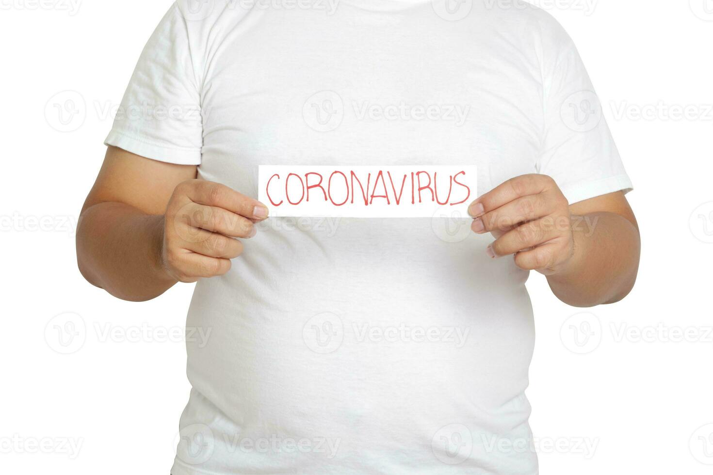 A fat man wearing a white T-shirt holds a paper sign written the words Coronavirus. The concept of health care for obese people Prevent virus infection. Clipping Path. White background photo