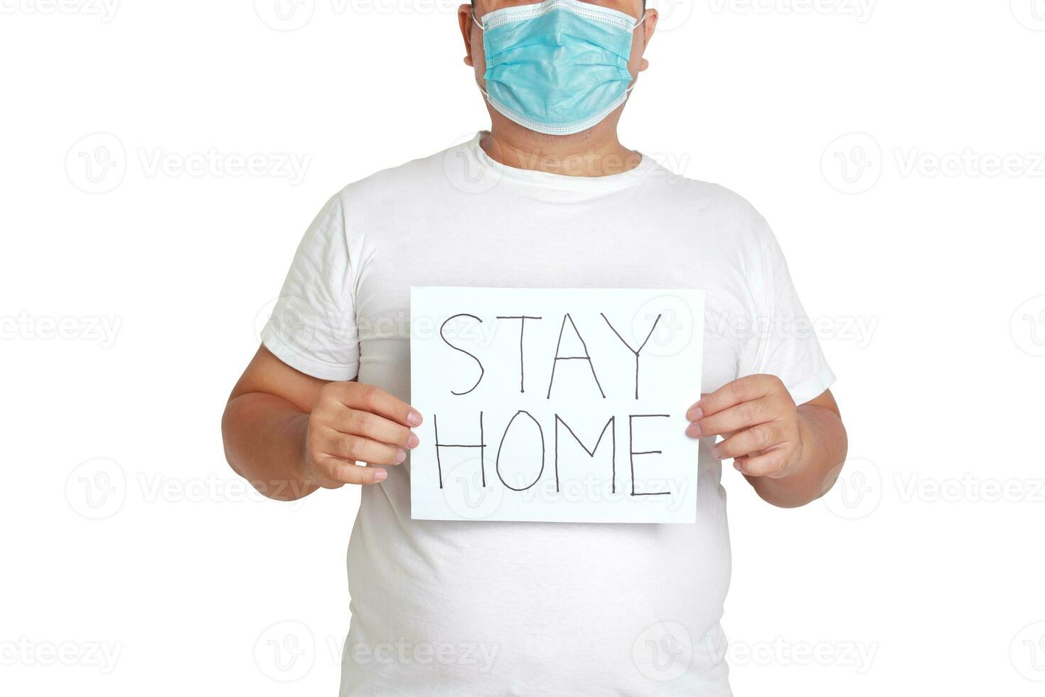 Fat man wearing a mask and white clothes Holding a paper sign, write the words stay home. Concept of health problems for obese people Prevention of coronavirus infection. White background. isolated photo