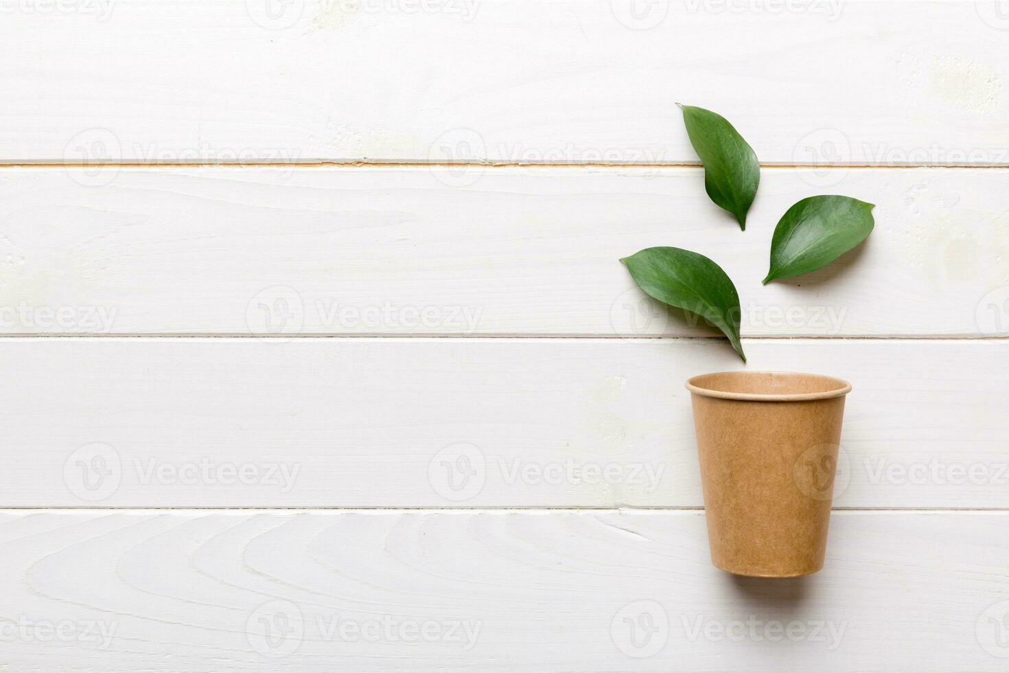 Zero waste cup with green leaf, environmentally friendly, disposable, cardboard, Eco-friendly coffee cup. top View with copy space photo