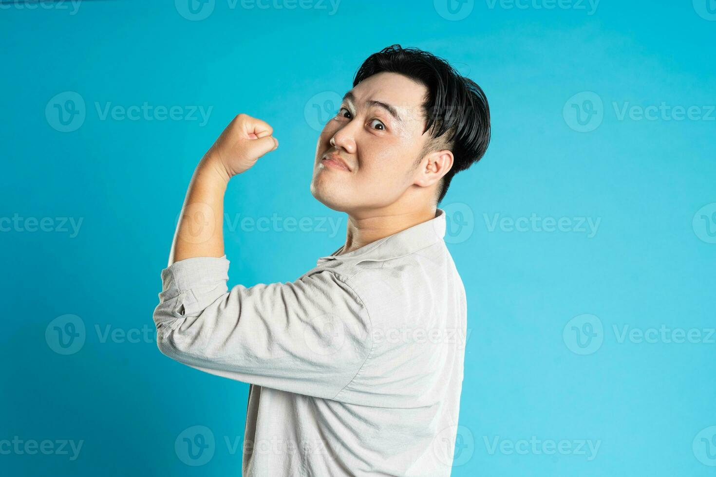 retrato de un asiático chico posando en un azul antecedentes foto