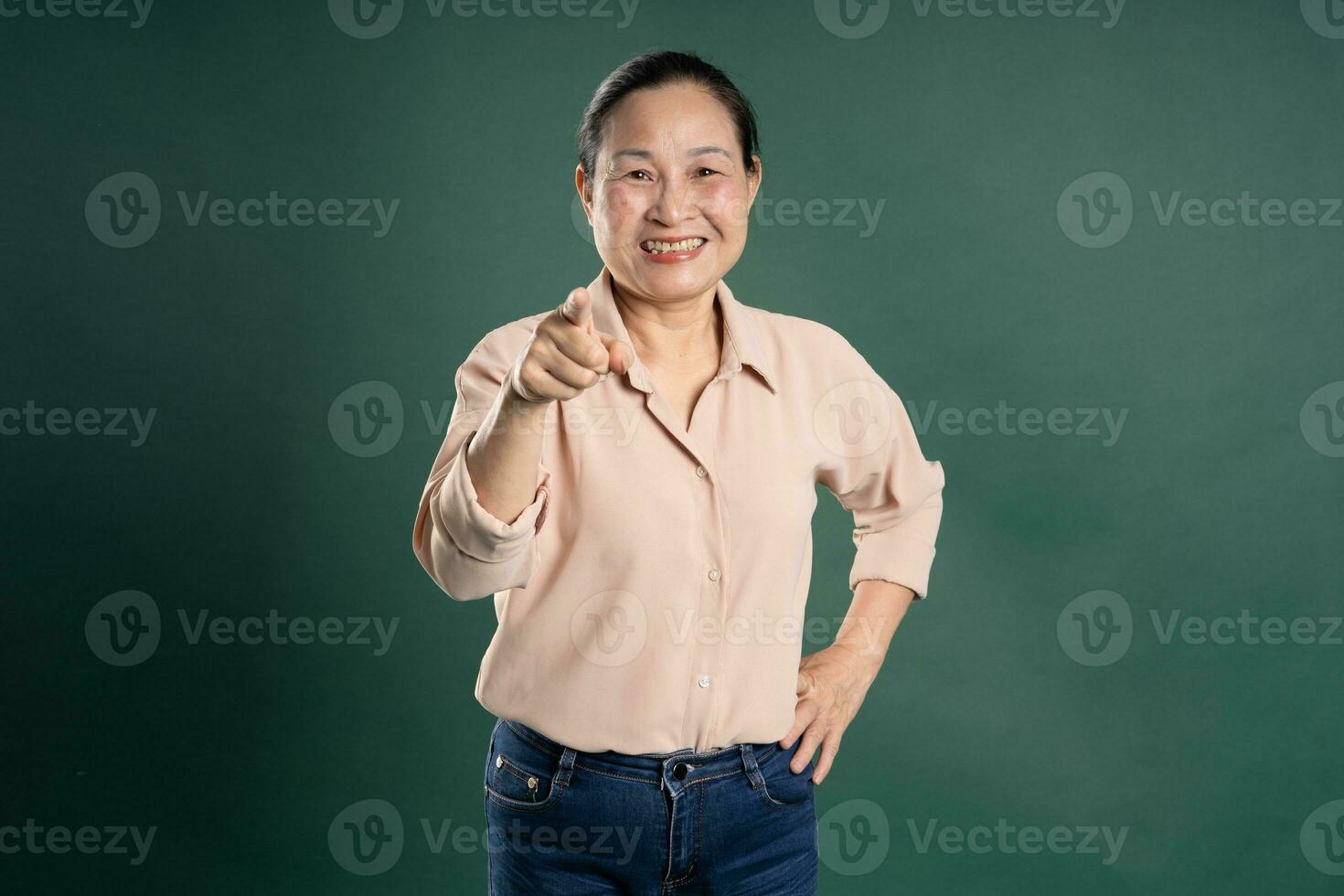 Gangang middle-aged Asian female portrait posing on blue background photo