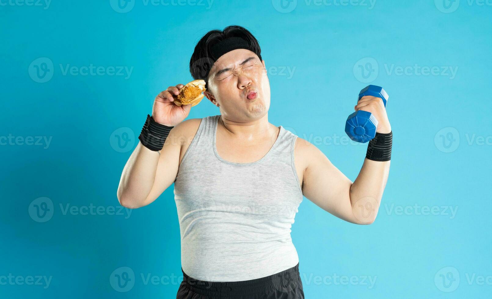 Image of Asian man exercising on blue background photo