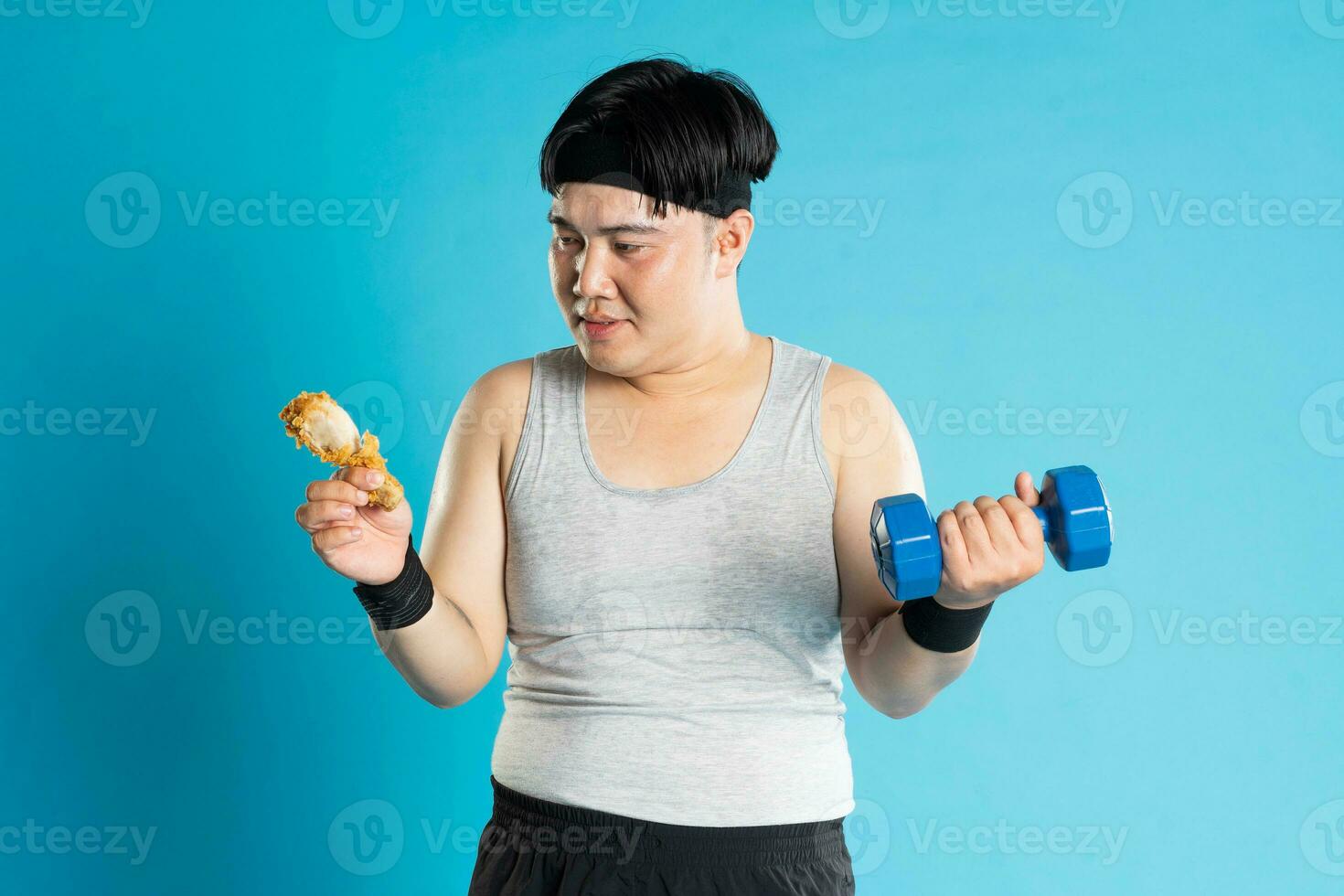 Image of Asian man exercising on blue background photo