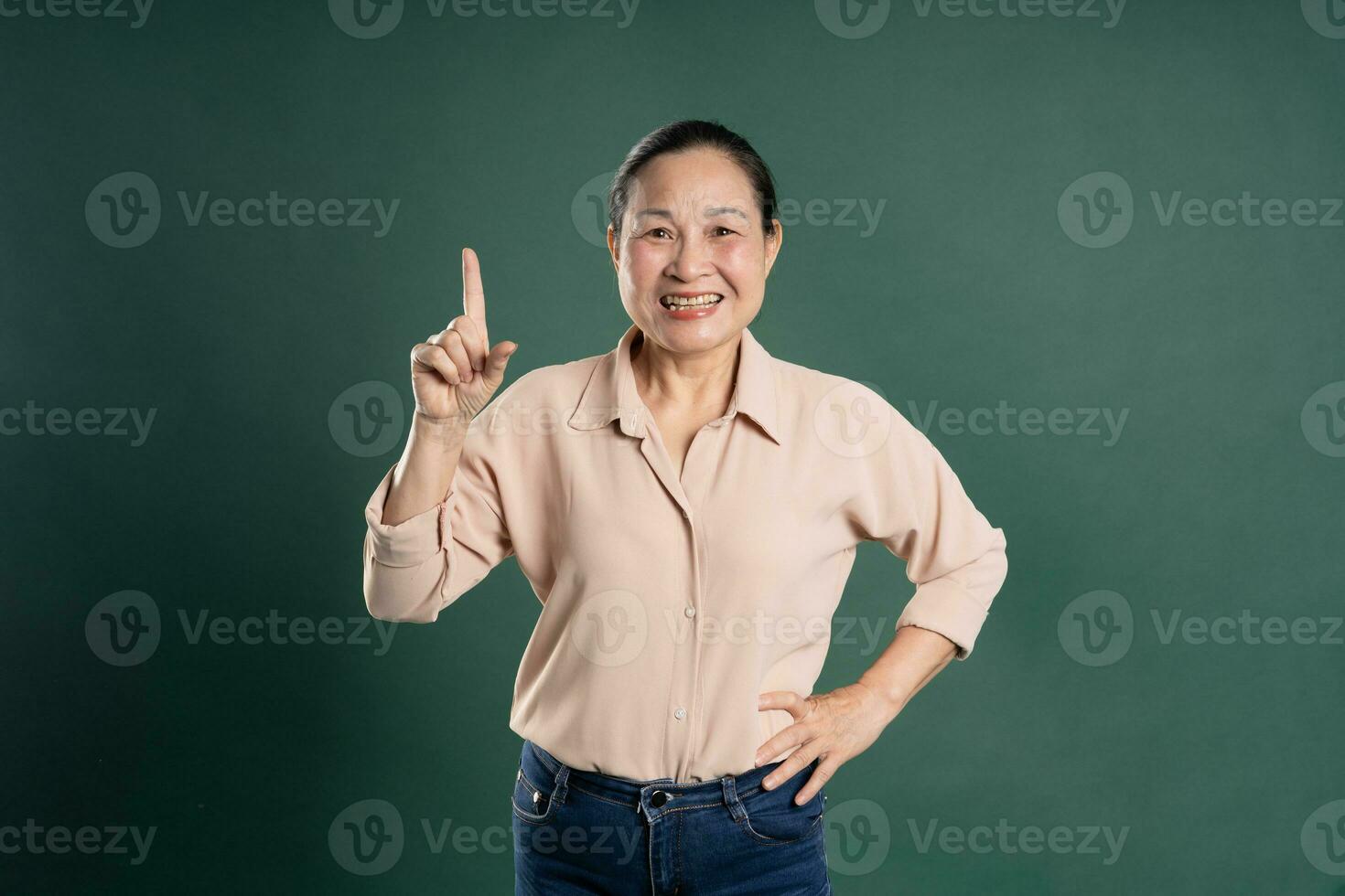 Gangang middle-aged Asian female portrait posing on blue background photo