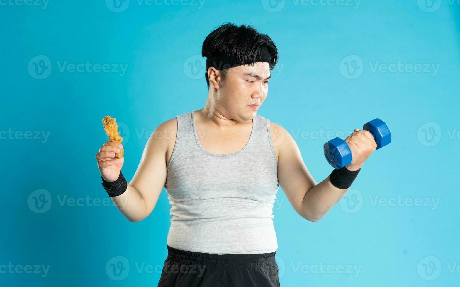 Image of Asian man exercising on blue background photo