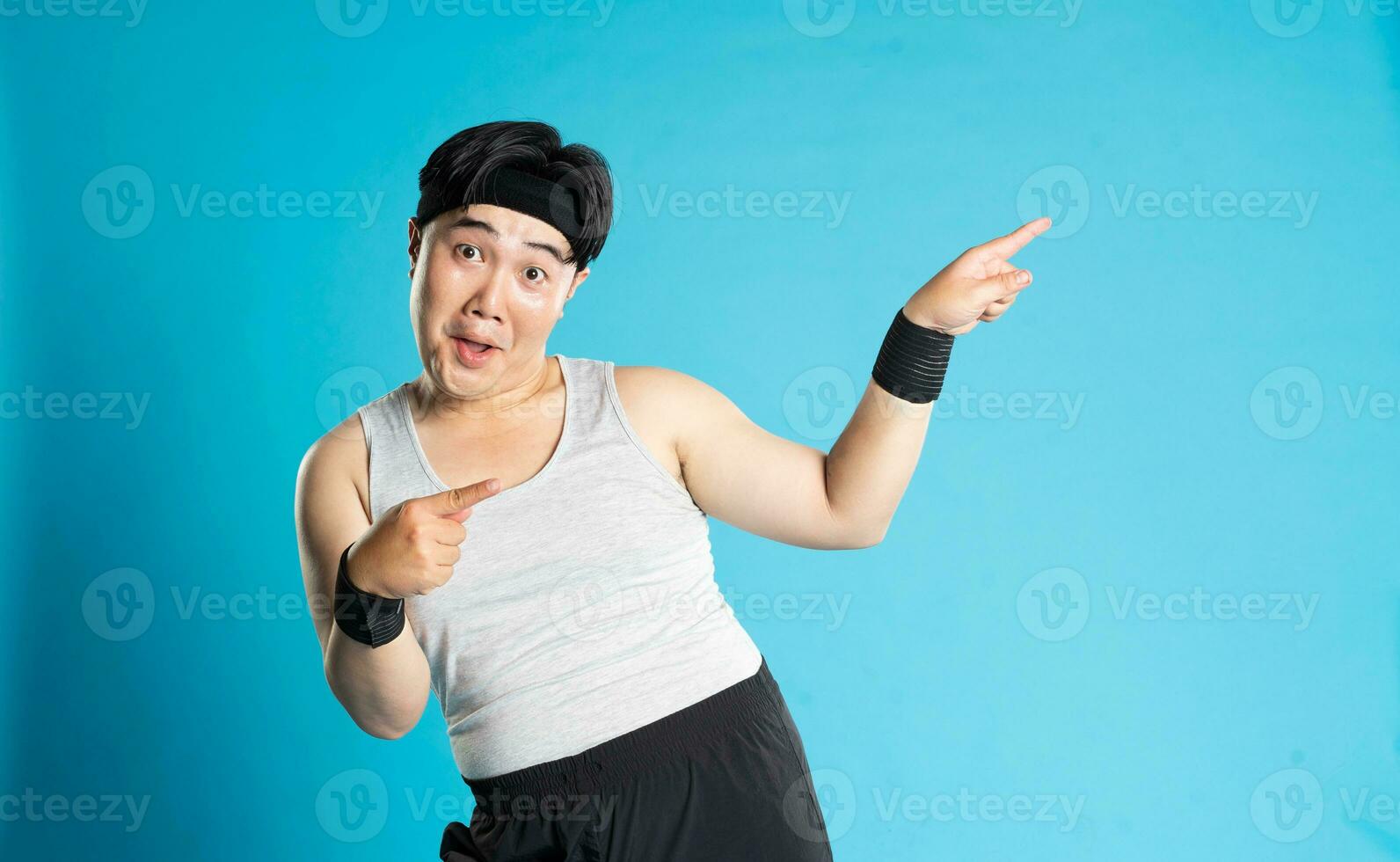 Image of Asian man exercising on blue background photo
