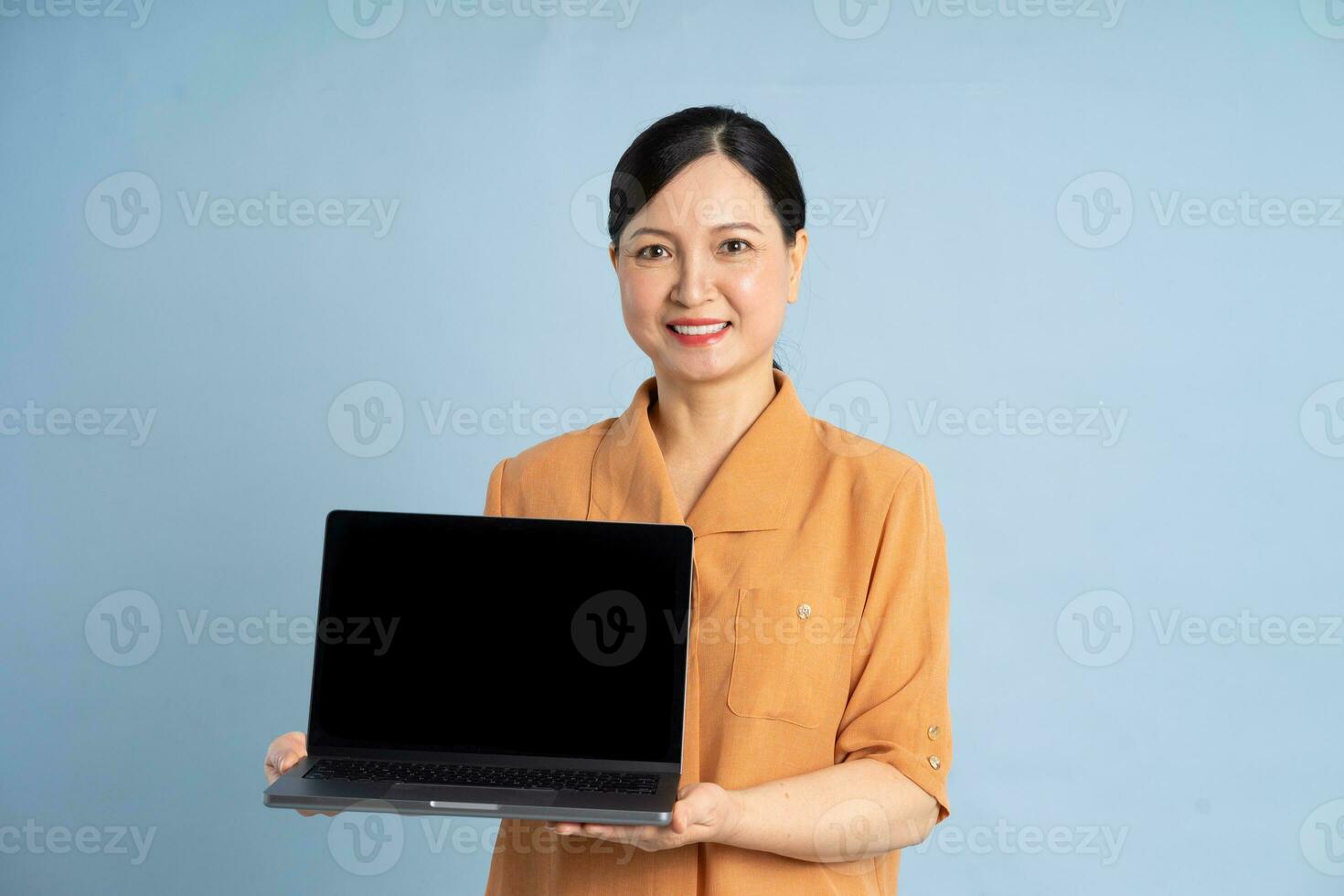 portrait of an elderly woman using a laptop photo