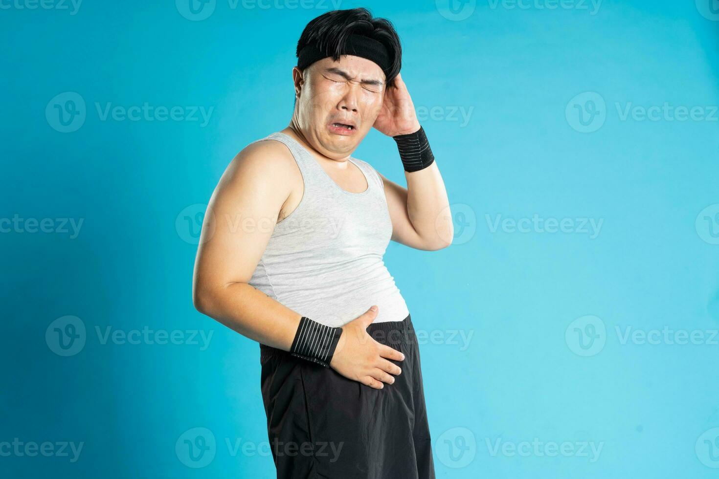 Image of Asian man exercising on blue background photo