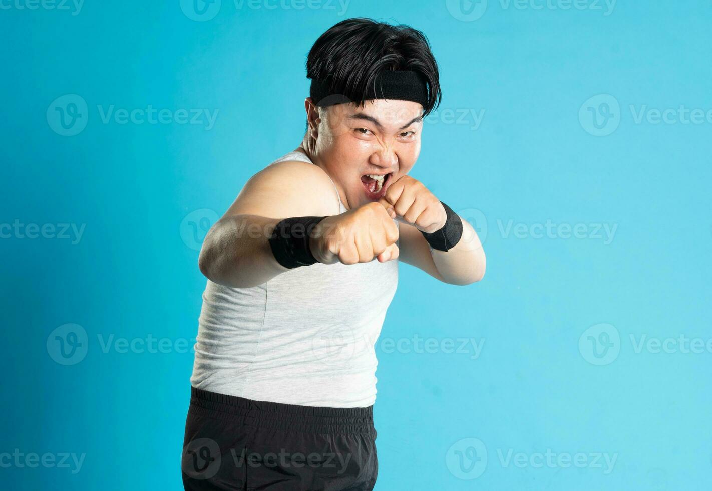 Image of Asian man exercising on blue background photo