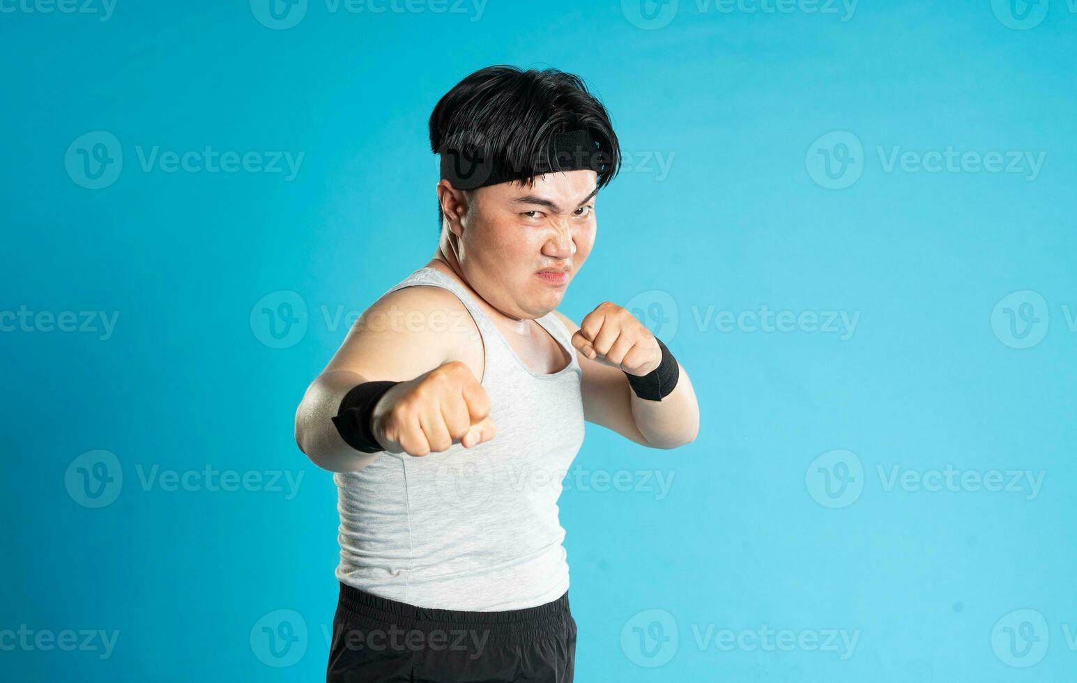 Image of Asian man exercising on blue background photo