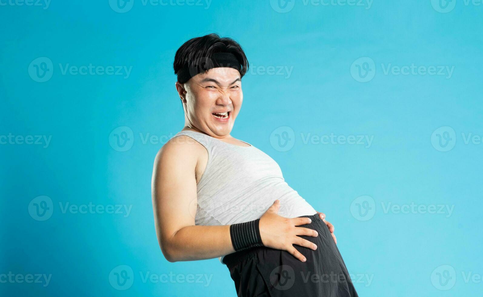 Image of Asian man exercising on blue background photo