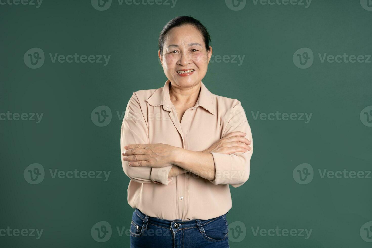 Gangang middle-aged Asian female portrait posing on blue background photo