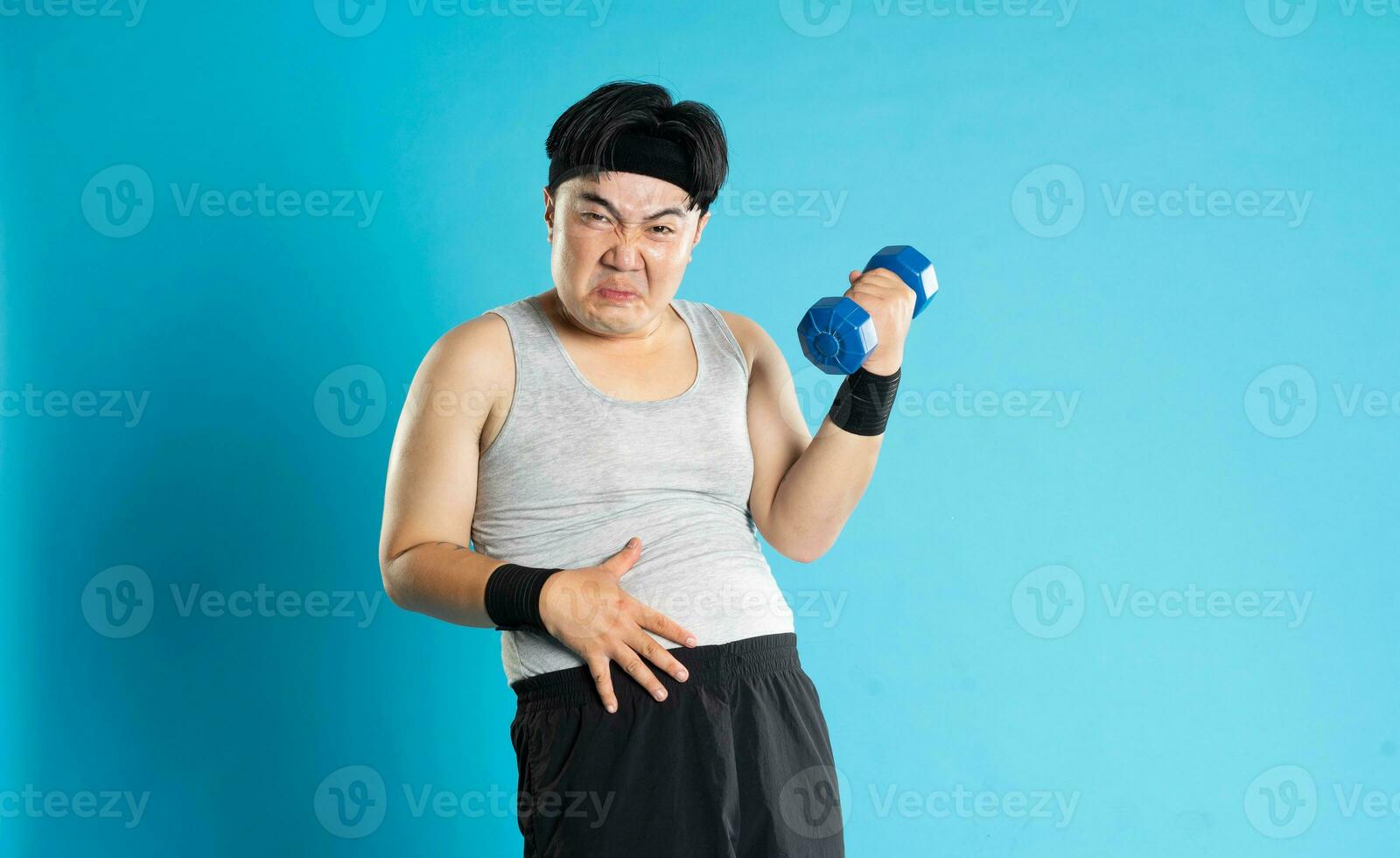 Image of Asian man exercising on blue background photo