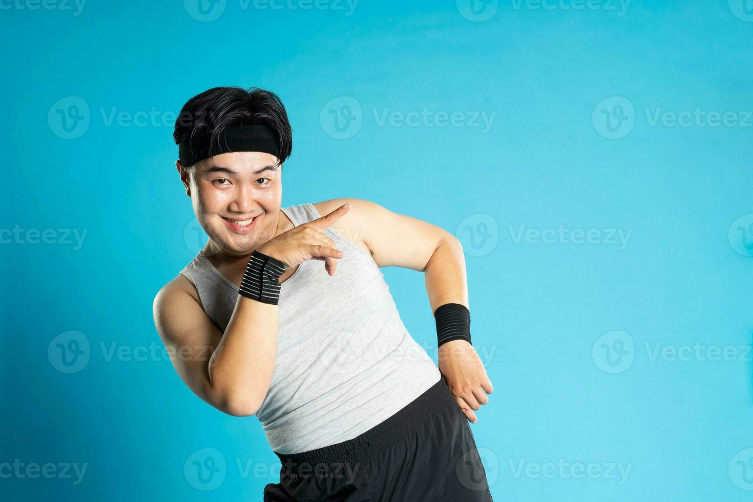 Image of Asian man exercising on blue background photo