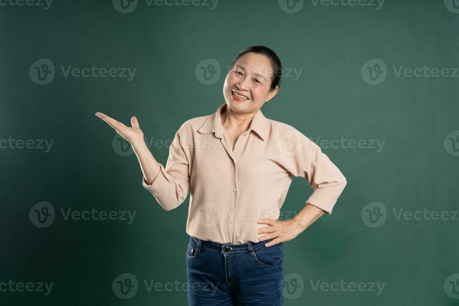 Gangang middle-aged Asian female portrait posing on blue background photo