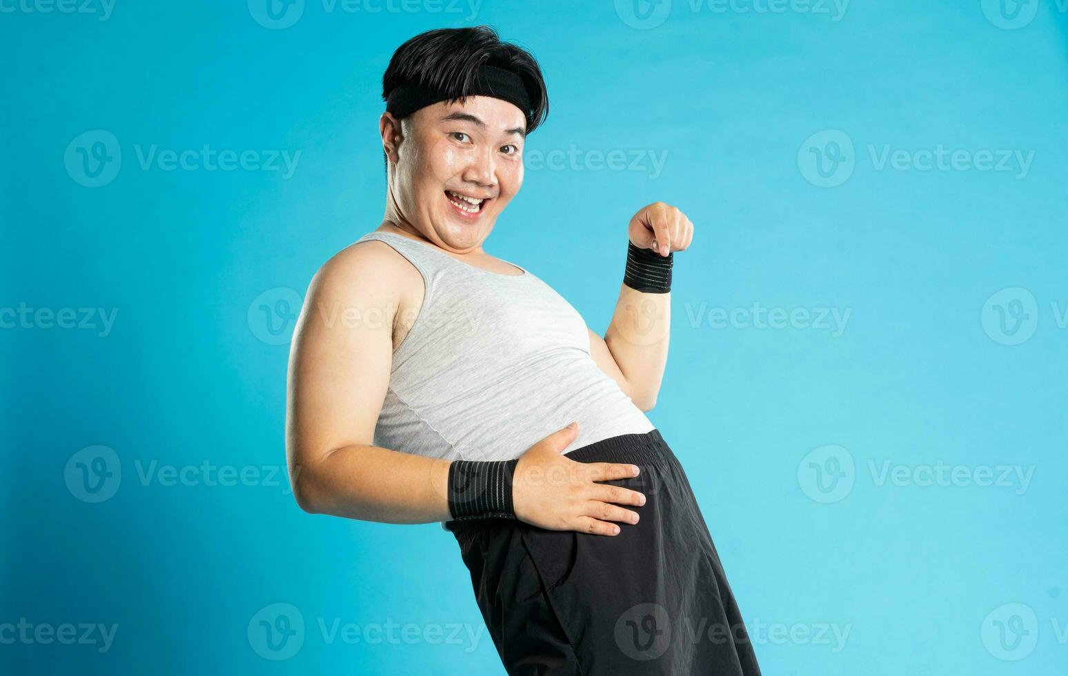 Image of Asian man exercising on blue background photo