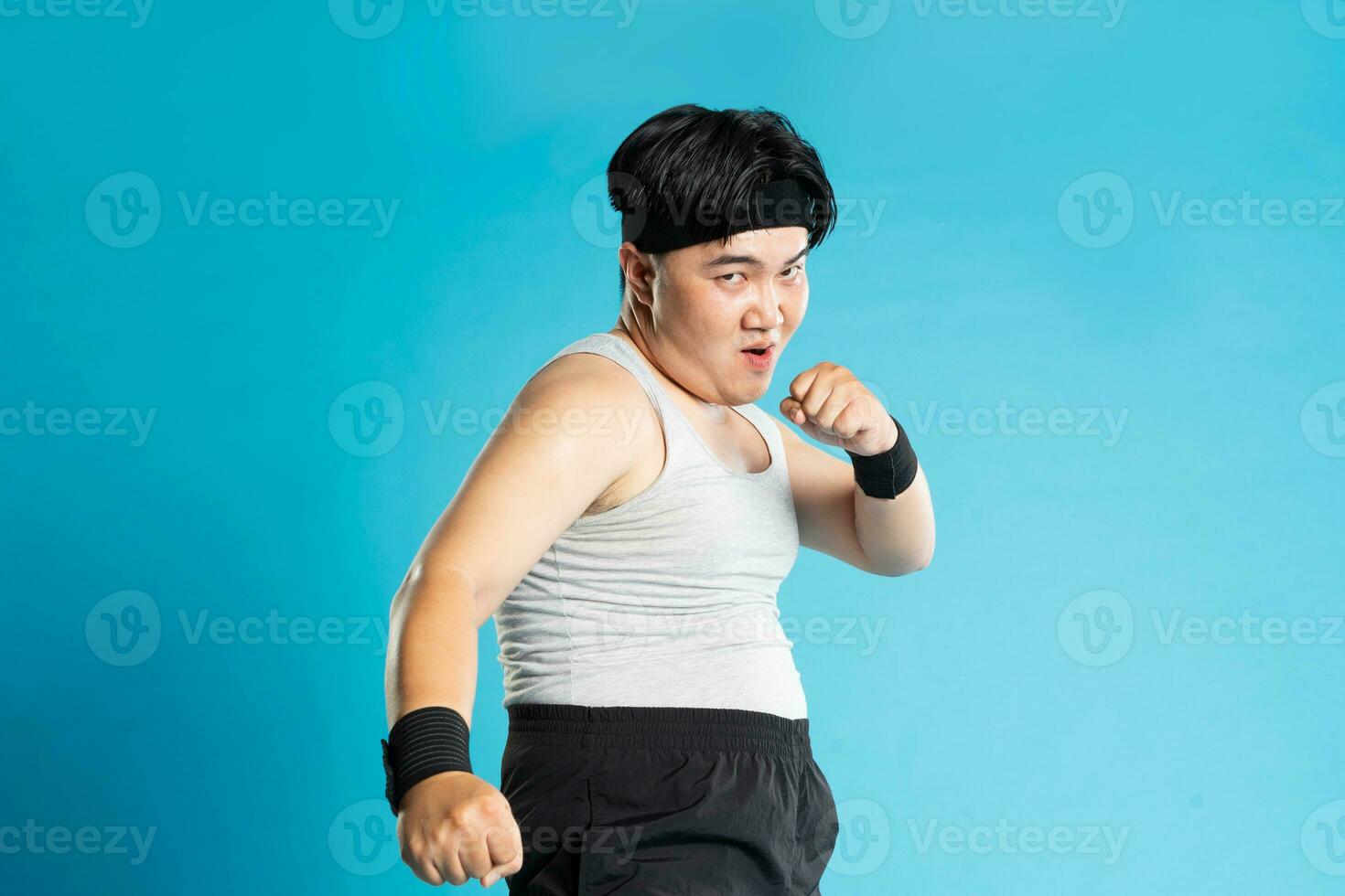 Image of Asian man exercising on blue background photo